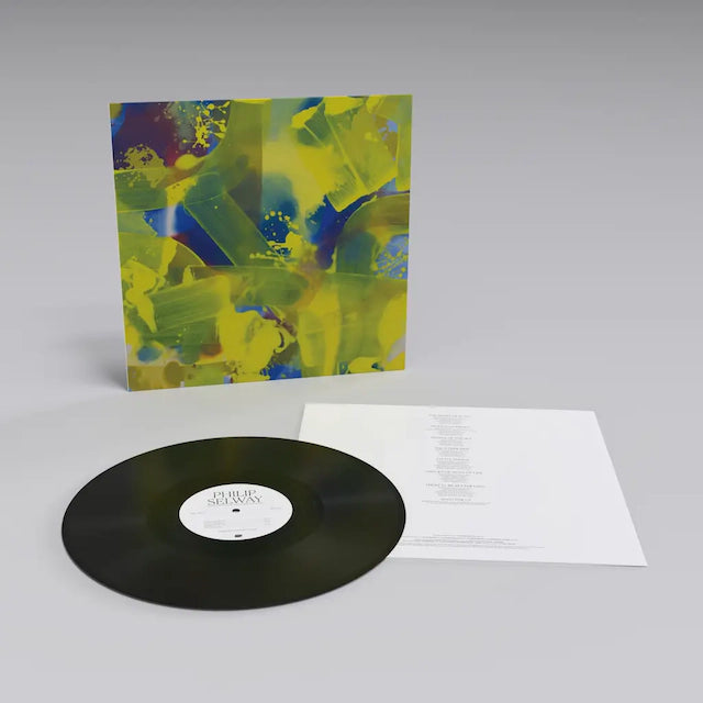 Vinyl record album with abstract yellow and blue artwork on the cover.