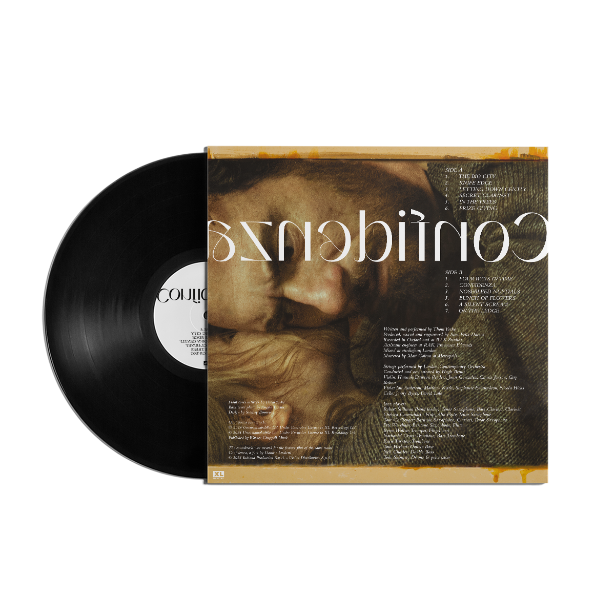 Vinyl record album with a cover featuring a blurred golden-toned image and reversed text.