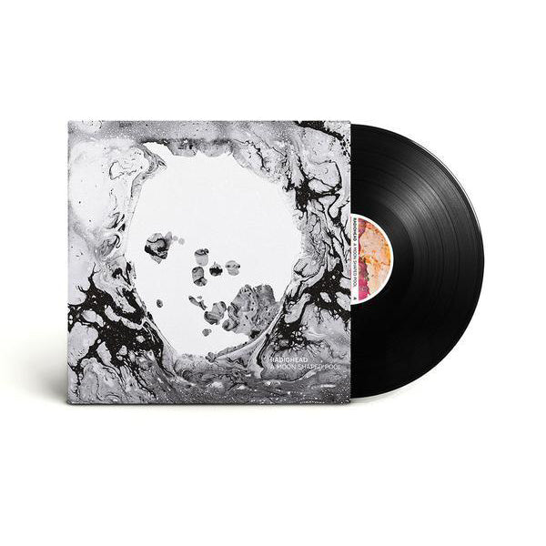 Vinyl record album with abstract black and white artwork on the cover.