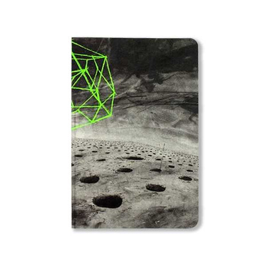 Notebook with a surreal lunar landscape cover featuring craters and a neon green geometric shape.