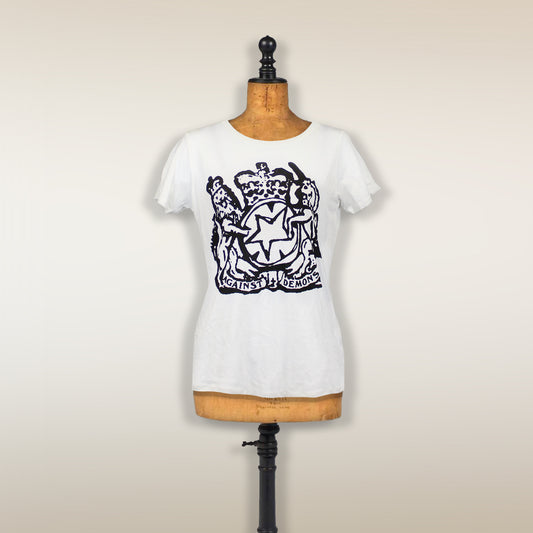 White t-shirt with a black heraldic crest design displayed on a dress form.